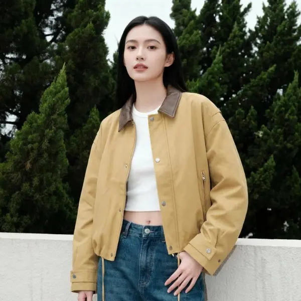 A Woman Stands Outdoors Wearing A Beige Jacket And Jeans Surrounded By Lush Green Trees